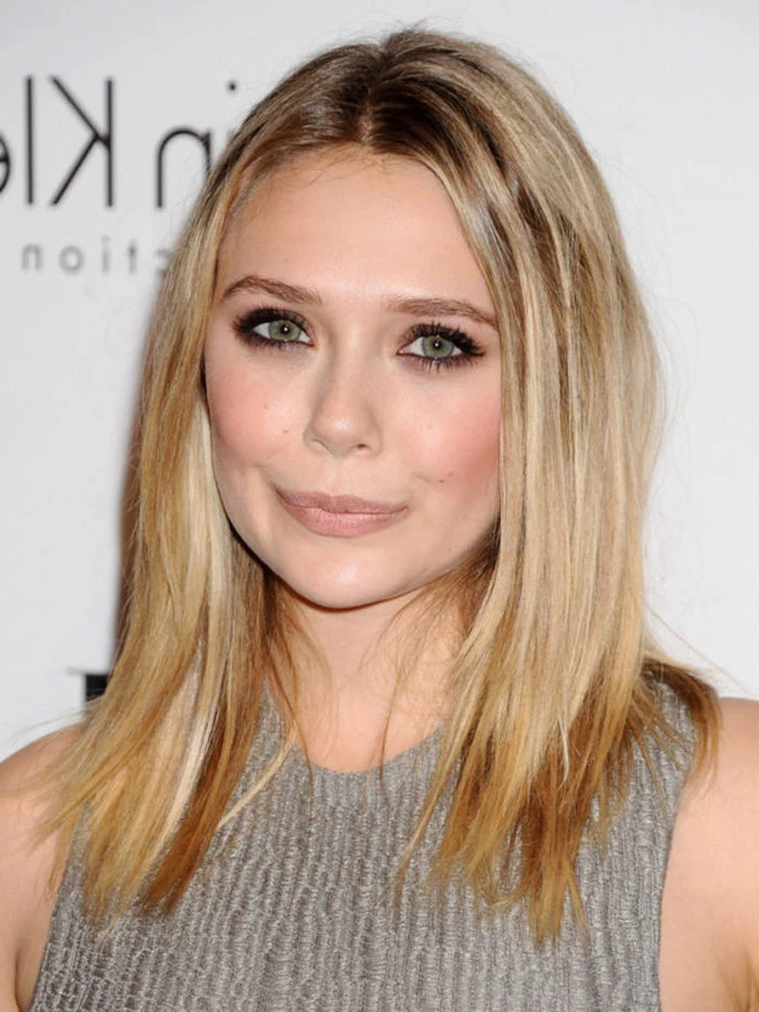 elizabeth olsen with blonde hair with highlights medium length hairstyles for thin hair wearing gray dress standing in front of white backdrop