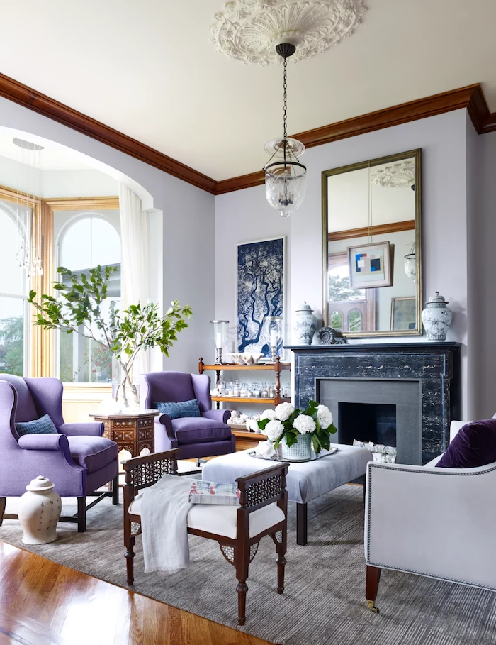 fireplace with black marble light purple walls colors that go with grey dark purple armchairs wooden floor