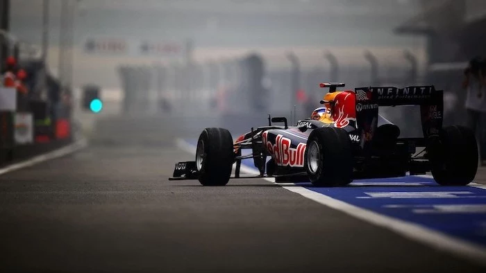 formula one car in black red bull written on it in red cool wallpapers for boys photographed on the race track