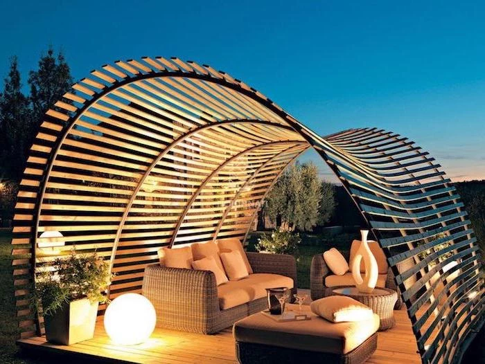 garden furniture set with beige cushions patio decor ideas arranged under curved wooden pergola