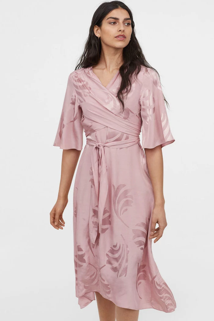 girl with long black wavy hair wearing pink satin wrap around dress long sleeve wedding guest dresses