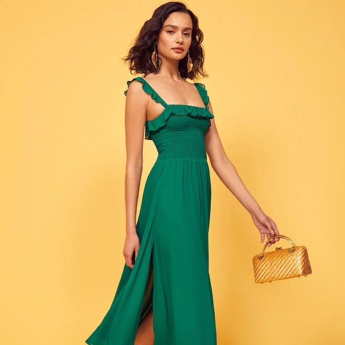 green dress worn by woman with shoulder length wavy brown hair elegant dresses for wedding guests small gold bag