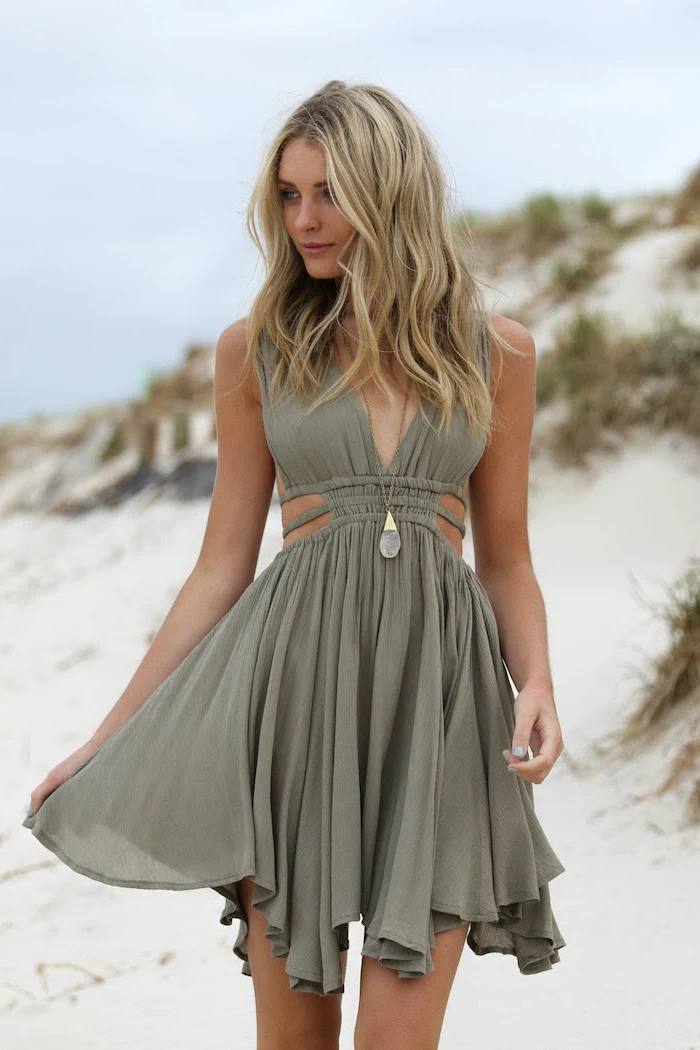 green pastel dress worn by woman with medium length blonde wavy hair womens casual summer dresses standing on the beach