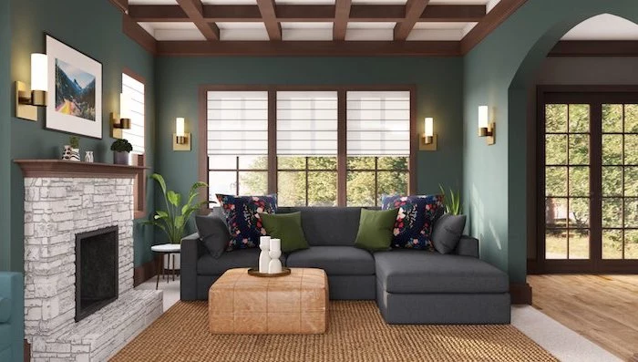 interior paint colors dark grey corner sofa with green throw pillows dark green walls exposed wood beams on the ceiling stone fireplace