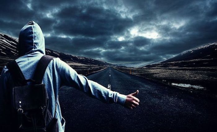 man hitchhiking on empty road wearing grey hoodie black backpack cool phone wallpapers dark sky