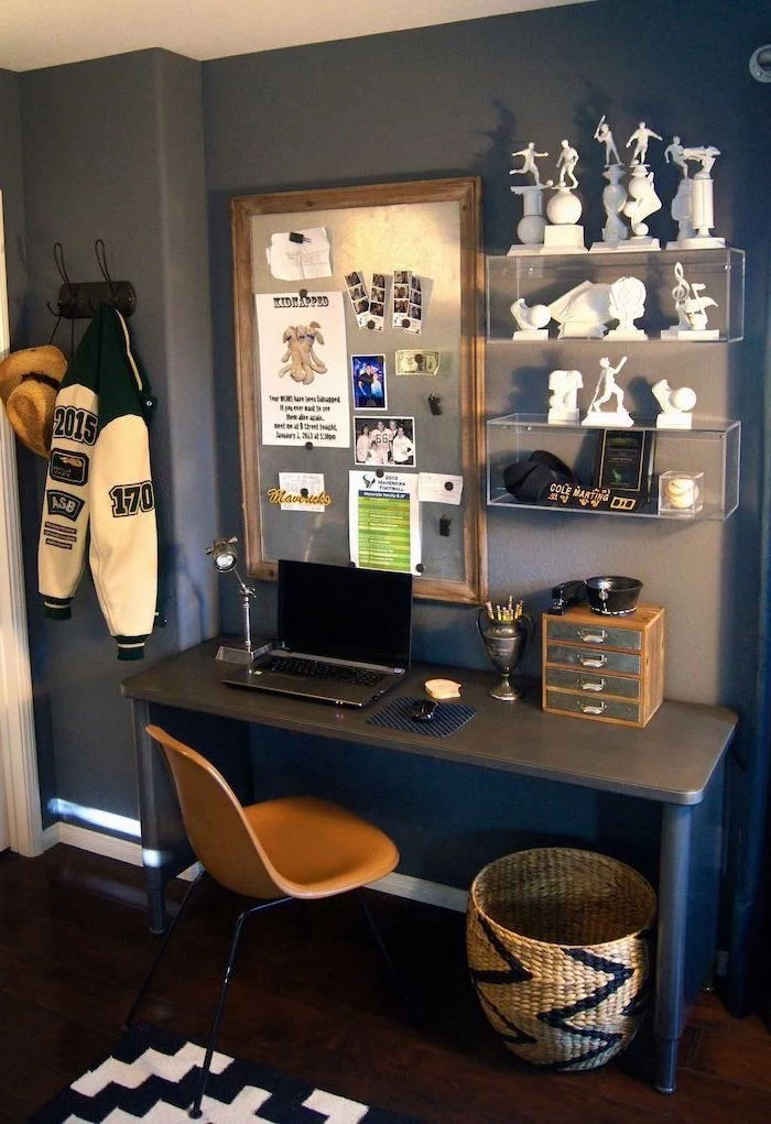 metal desk with laptop magnetic board on the grey wall orange chair plastic bookshelf boys room colors wooden floor
