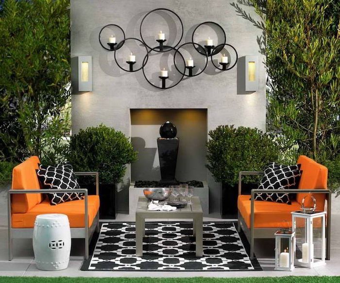 orange cushions on two armchairs wooden coffee table black and white throw pillows and carpet patio decor ideas