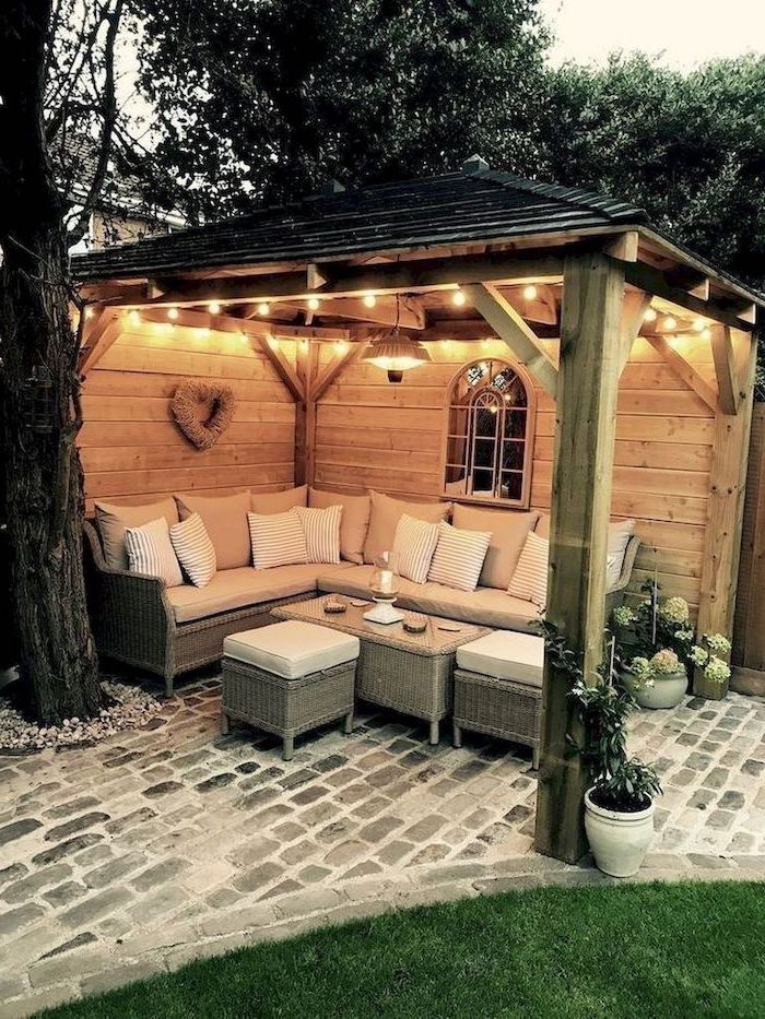 patio cover ideas paved floor large garden furniture set with beige cushions under wooden pergola with strings of lights