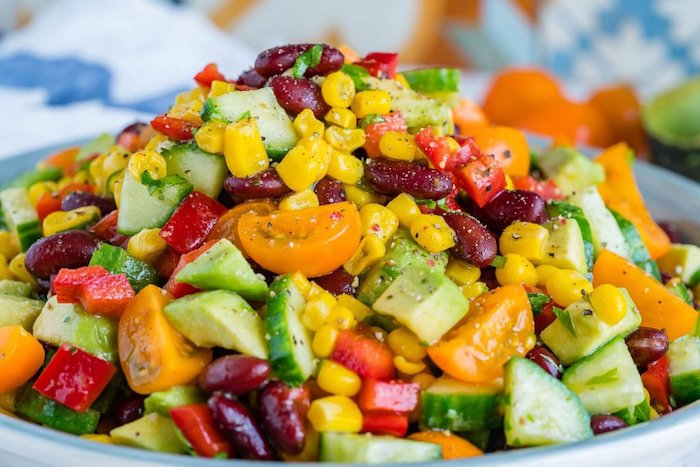 salad with cucumbers halved cherry tomatoes peppers corn and beans salads for a crowd avocado