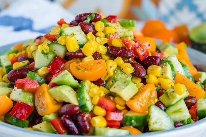 salad with cucumbers halved cherry tomatoes peppers corn and beans salads for a crowd avocado