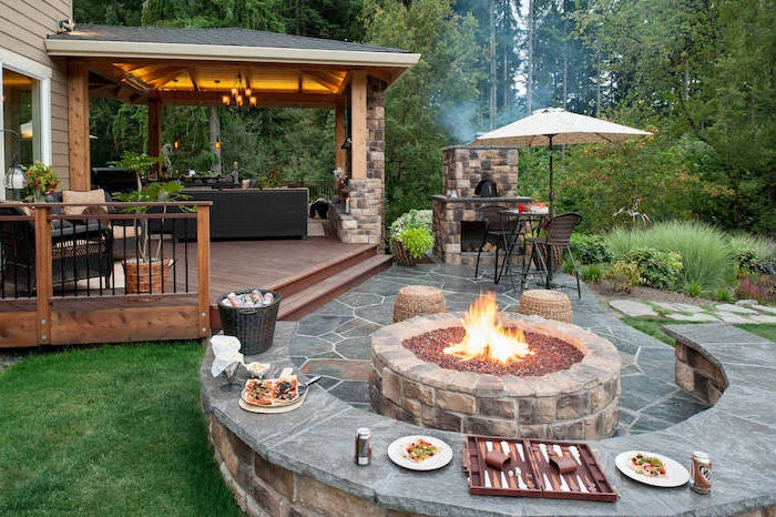 small backyard landscaping ideas grill station with small table stone bench around fire pit stone floor