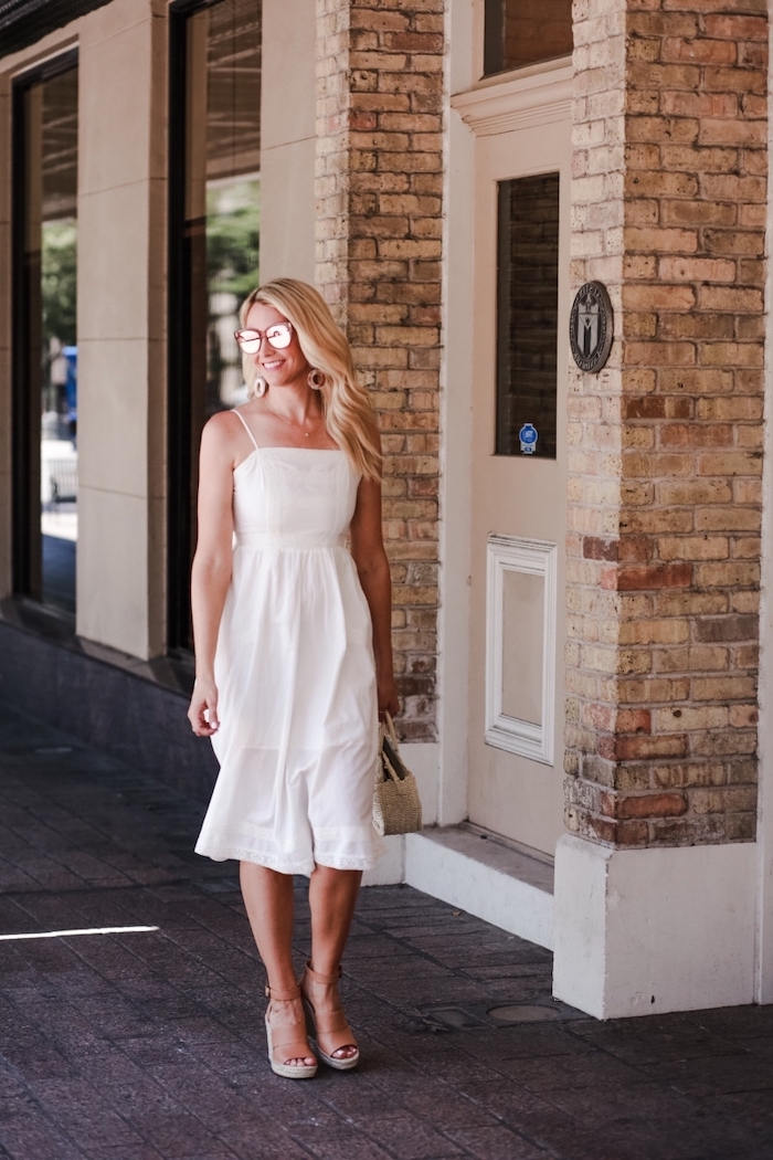 summer dresses with sleeves blonde woman with wavy hair wearing flowy white dress sunglasses beige sandals