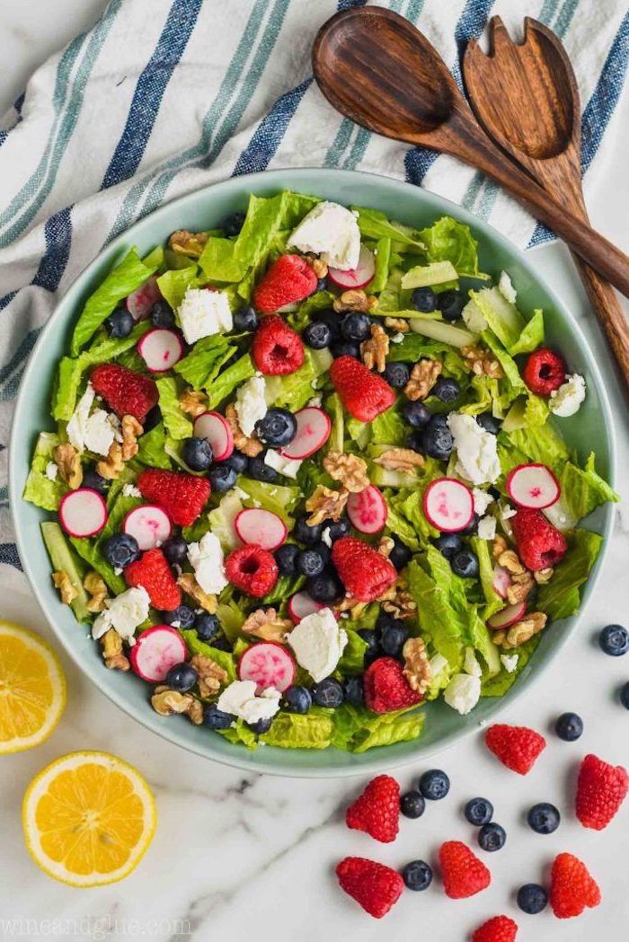 summer pasta salad with green lettuce turnip blueberries raspberries crumbled feta cheese in blue ceramic bowl