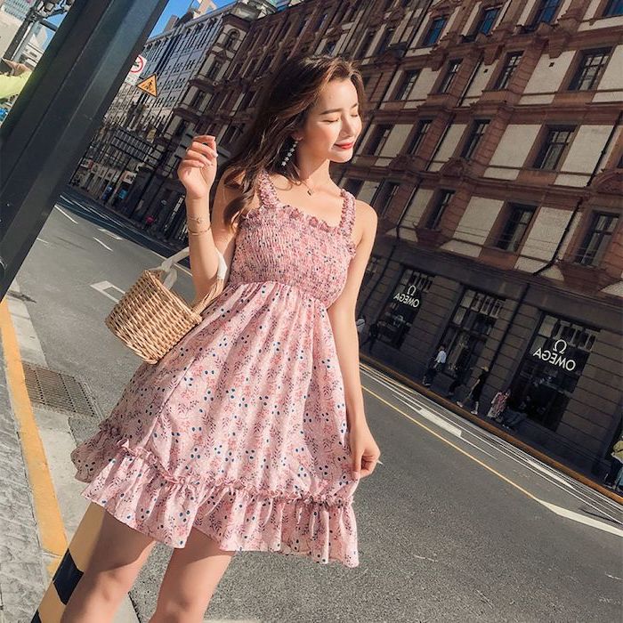 woman wearing pink dress with white and blue flowers summer beach dresses standing on the sidewalk