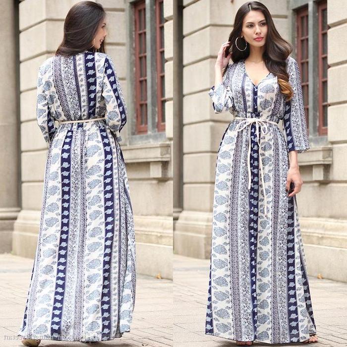 woman with long brunette wavy hair wearing long white dress with dark blue decorations summer dresses with sleeves standing on sidewalk