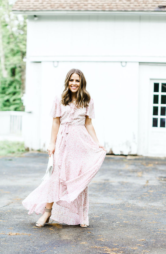 woman with medium length brown hair wearing long white dress with pink flowers dresses to wear to a summer wedding wrap around dress