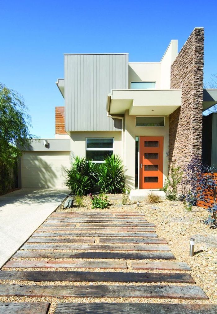 wooden beams surrounded by gravel pathway front yard landscaping ideas small bushes planted in front of the front door