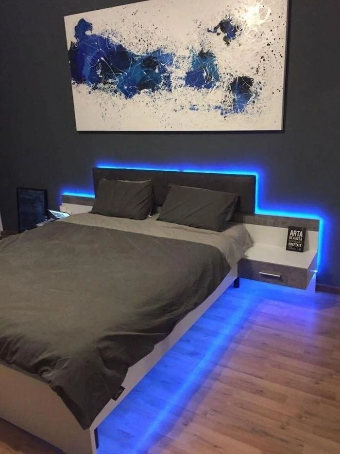 wooden floor boys room paint ideas twin bed with grey bed sheets blue led lights underneath blue white poster above the bed