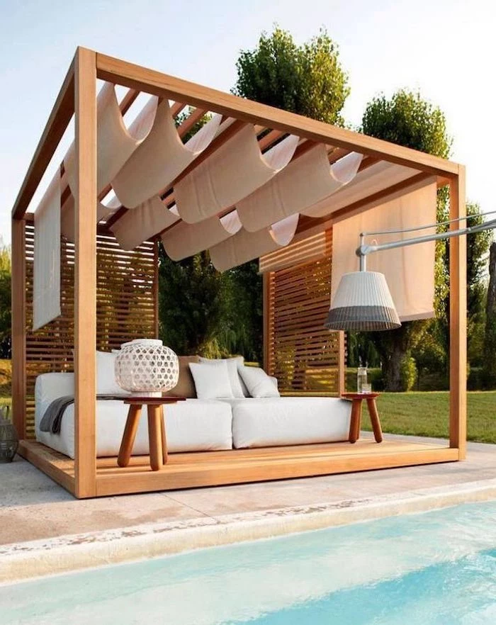 wooden pergola with white curtains enclosed patio ideas white sofa underneath with small wooden coffee tables