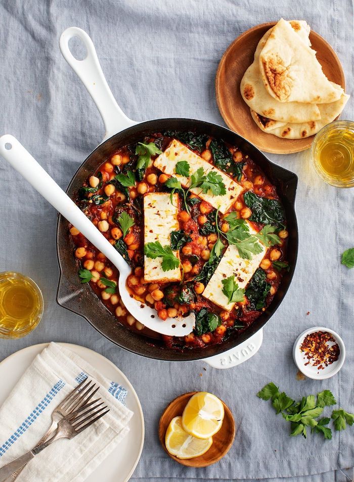 baked feta cheese with chickpeas in tomato sauce with spinach vegan chickpea recipes garnished with parsley