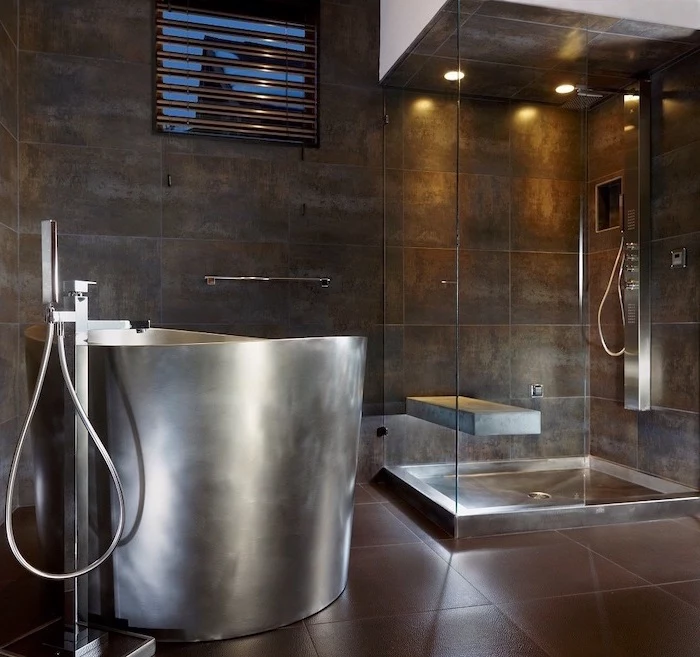 bathroom decor ideas stainless steel bathtub dark brown tiles on walls and floor glass shower cabin