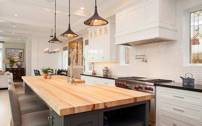 black kitchen island with wooden countertop velvet bar stools modern farmhouse kitchen decor white subway tiles backsplash