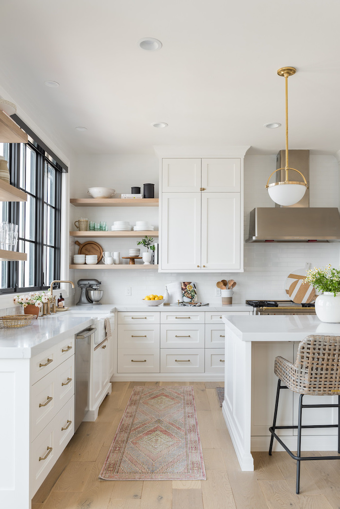 black metal bar stools next to white kitchen island farmhouse kitchen cabinets white cabinets white tiles backsplash wooden floor