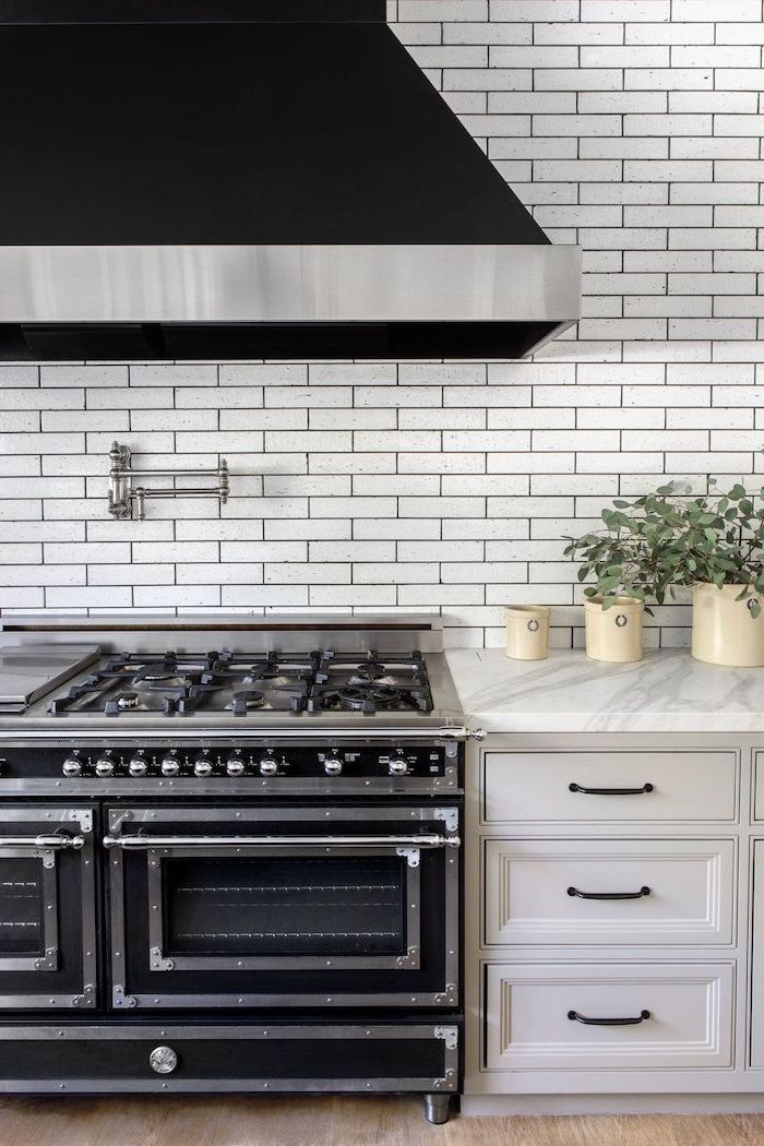 black stove and kitchen hood backsplash for white cabinets white subway tiles white cabinets marble countertop