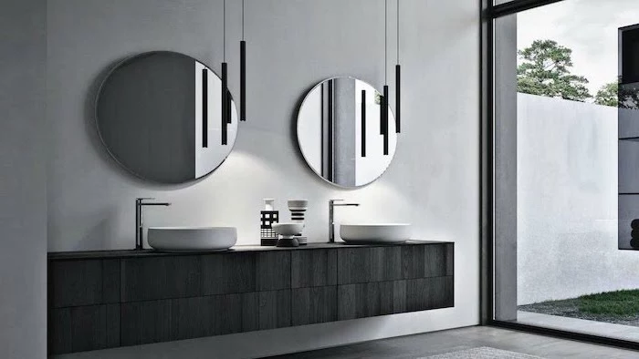 black wooden floating cabinet with two sinks two round mirrors above them small bathroom designs with shower gray wall tall windows