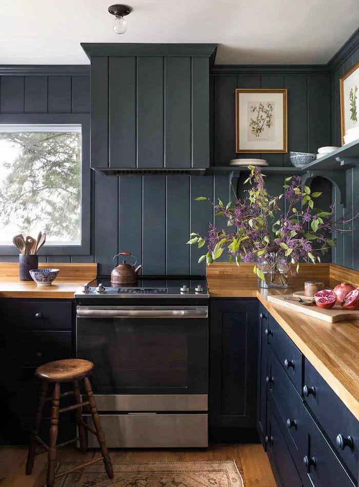 black wooden wall dark blue cabinets drawers farmhouse white kitchen cabinets wooden countertop and floor open shelving