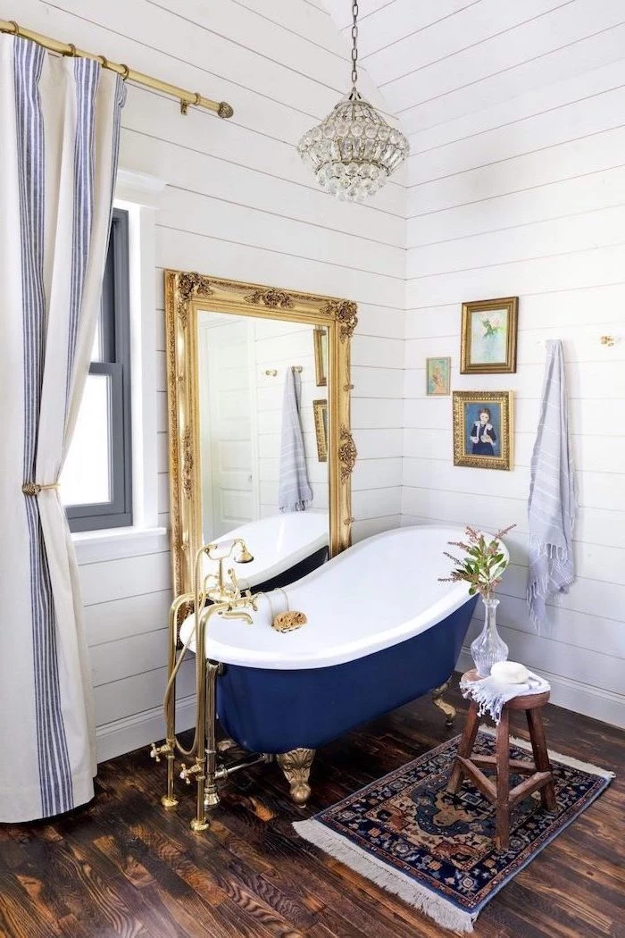 blue and white vintage bathtub vintage mirror next to it bathroom decorating ideas pictures wooden floor and walls