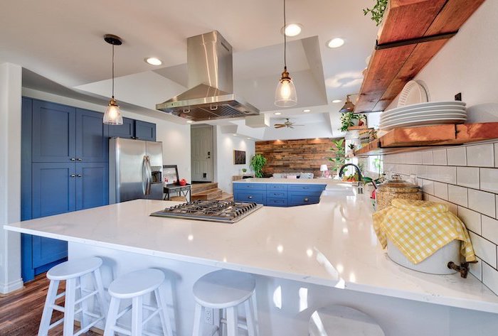 blue cabinets white countertops modern farmhouse kitchen open shelving wooden backsplash white tiles on the other wall