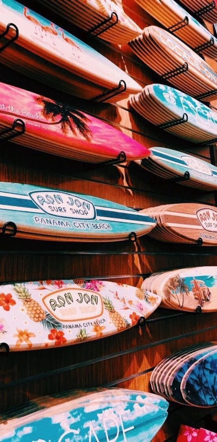 blue pink purple orange white surfboards arranged on wooden wall with different summer themed prints on them vsco wallpaper