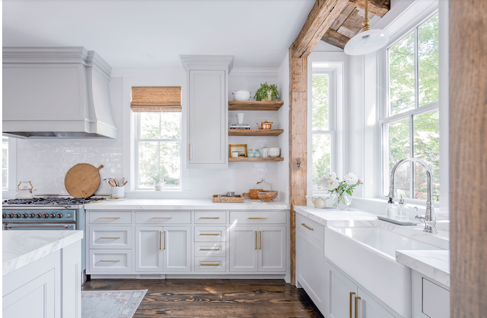 bouquet of peonies on white countertop white cabinets modern farmhouse kitchen decor wood beams on the wall open shelving wooden floor