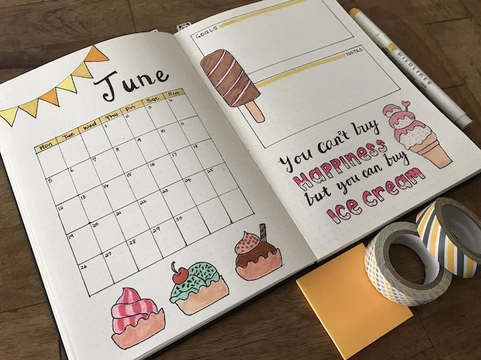 bulet journal page for june with ice cream drawn all over it bullet journal ideas notebook placed on wooden surface