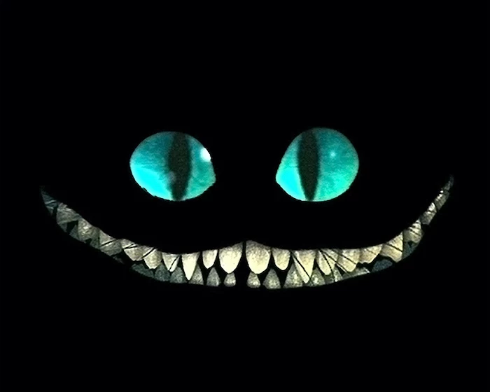 cheshire cat smiling high resolution desktop wallpaper turquoise eyes large smile with teeth on black background