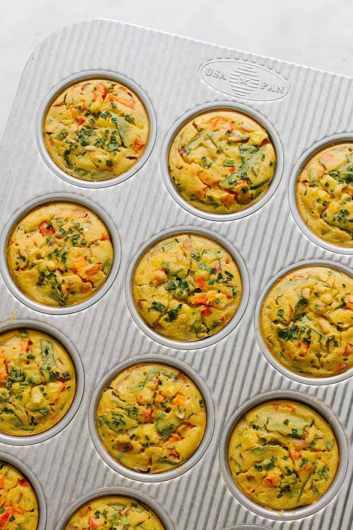 chickpea frittata with herbs and tomatoes baked in muffin baking tray roasted chickpeas snack placed on white surface