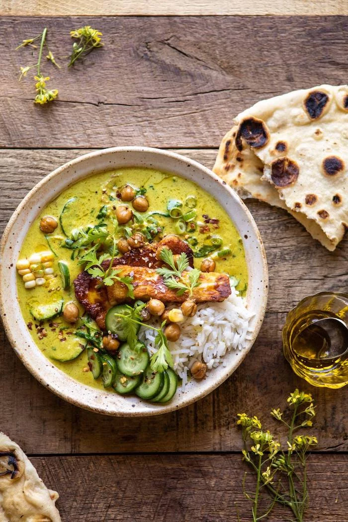 coconut chickpea curry with rice and fried halloumi how to roast chickpeas placed in white ceramic bowl on wooden surface