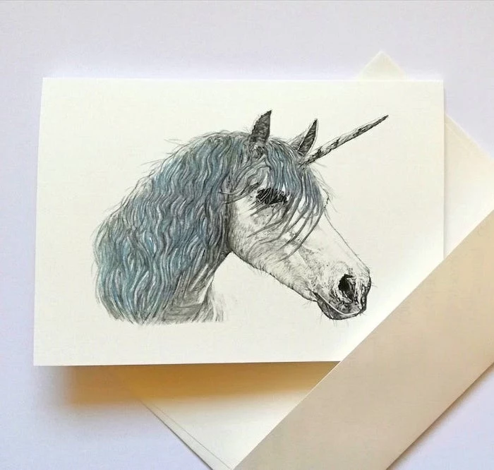 drawing of a unicorn with black and blue pencil on white background how to draw animals step by step