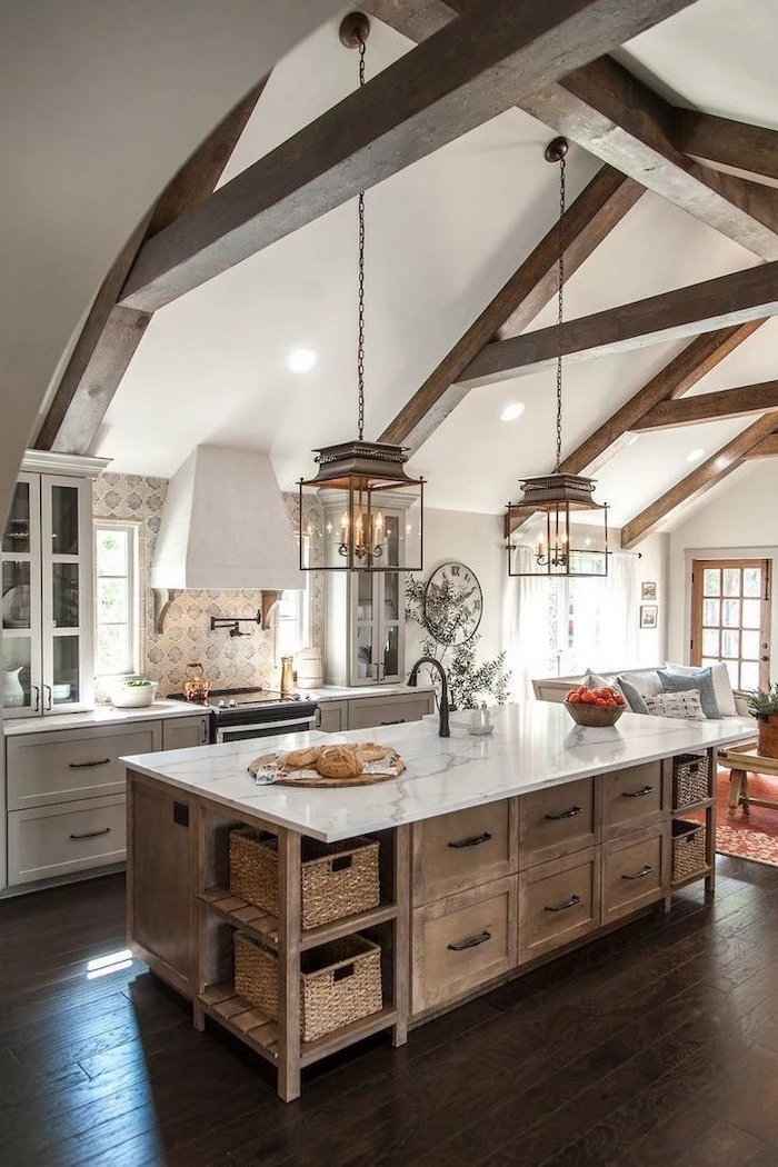 exposed wood beams on cathedral ceiling farmhouse kitchen decor wooden kitchen island with marble countertop vintage patterned tiles backsplash