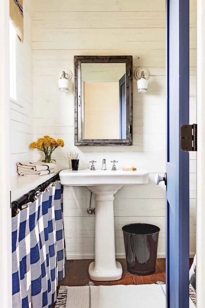farmhouse bathroom blue dorr blue and white curtain small bathroom remodel vintage sink with mirror above it wooden floor
