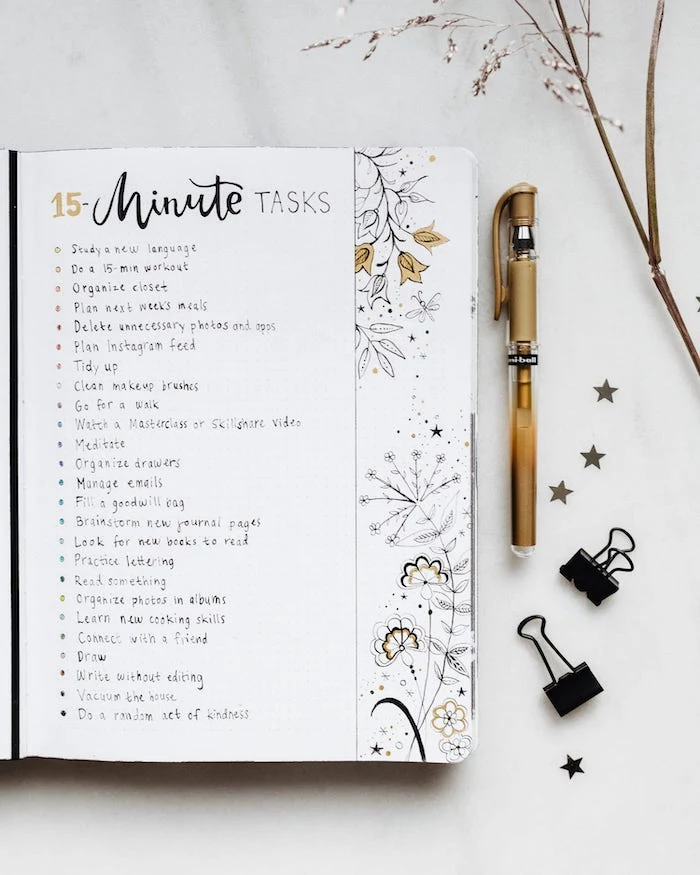 fifteen minute tasks list with flowers drawn at the end of the page mood tracker bullet journal white notebook