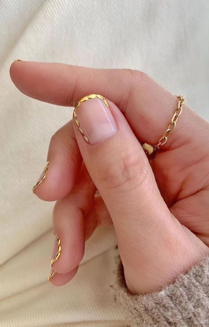 gold decorations along the edges of short squoval nails with transperant nail polish nail ideas 2020