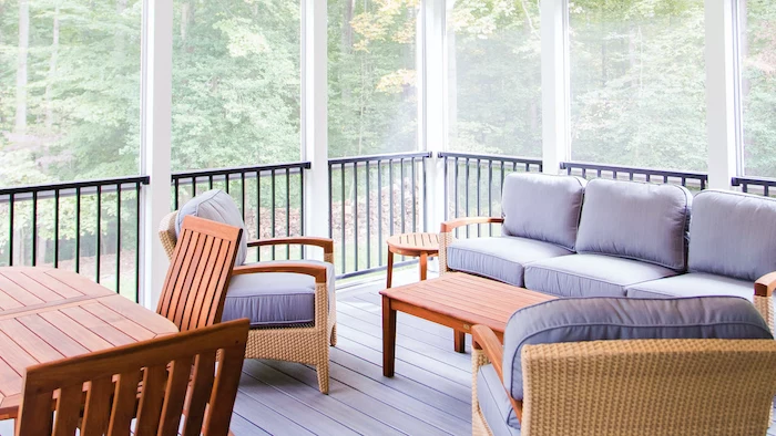 gray cushions on wooden garden furniture set screened in back porch wooden coffee table placed on wooden floor