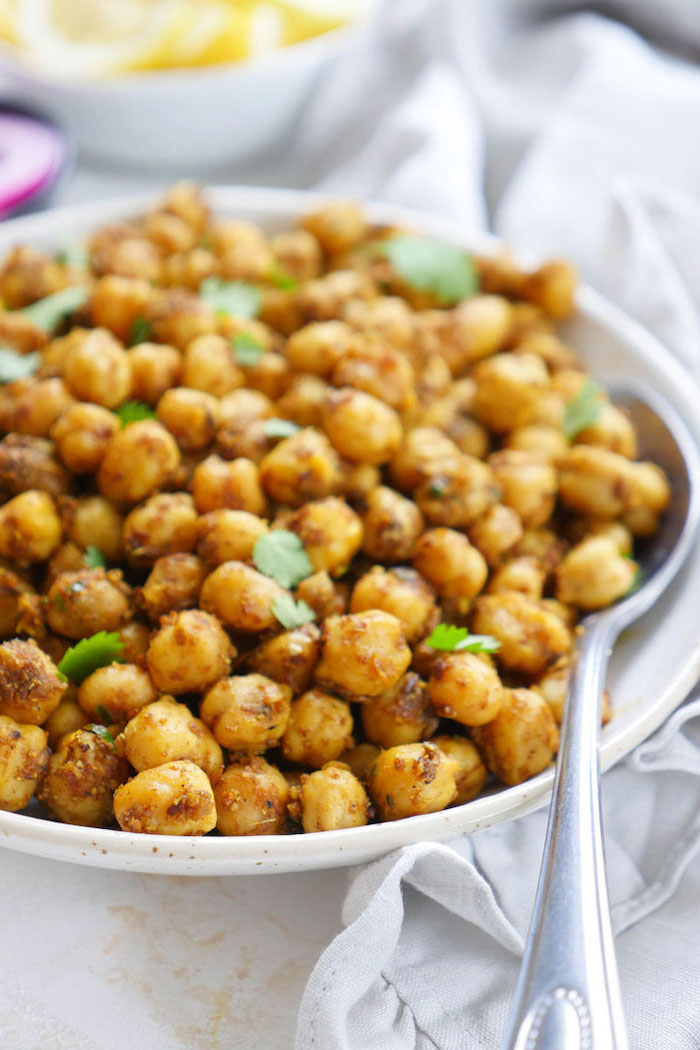 how to roast chickpeas spicy indian stirfry recipe garnished with chopped parsley placed in white bowl