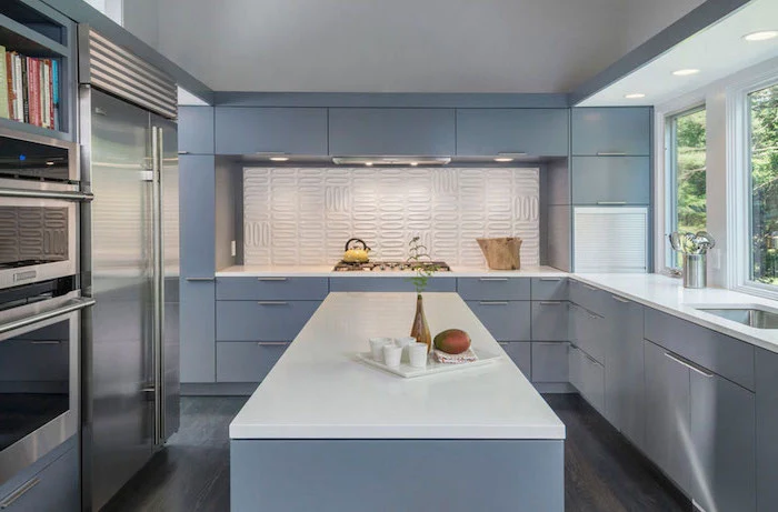 light blue cabinets and kitchen island with white countertops subway tile backsplash white backsplash