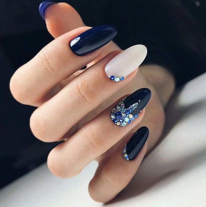 nail ideas 2020 dark blue and white nail polish decorations with blue and white rhinestones on pinky ring and middle fingers