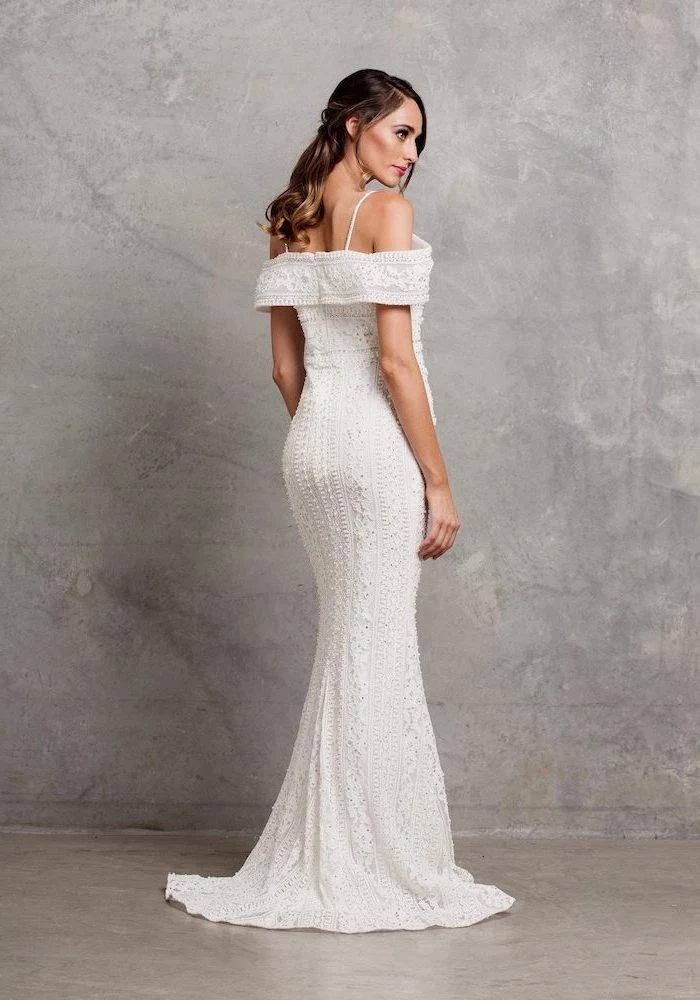 off the shoulder mermaid wedding dress lace wedding dress with spaghetti straps worn by woman with brunette wavy hair