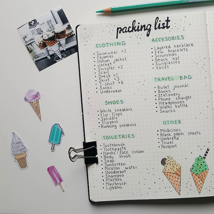 packing list for travelling written on white notebook bullet journal ideas ice creams drawn on the page