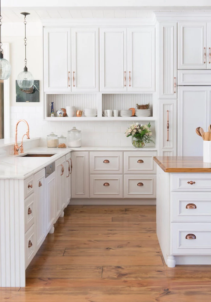 rose gold fixtures white cabinets white marble countertops farmhouse kitchen decor wooden floor white kitchen island with wooden countertop